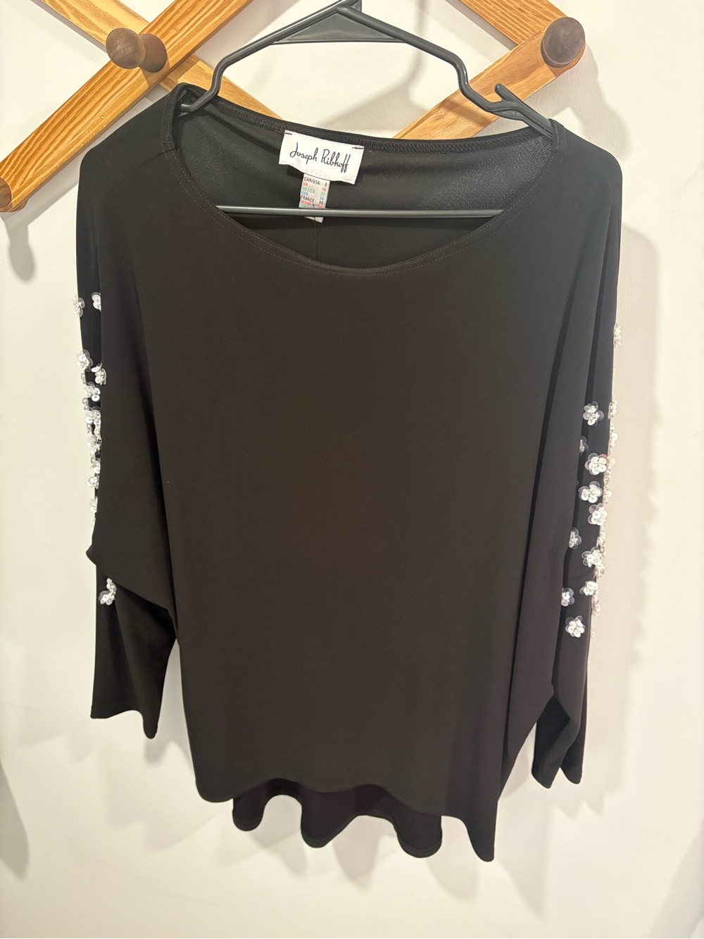 Joseph Ribkoff black batwing top features intricate white sequin flower details